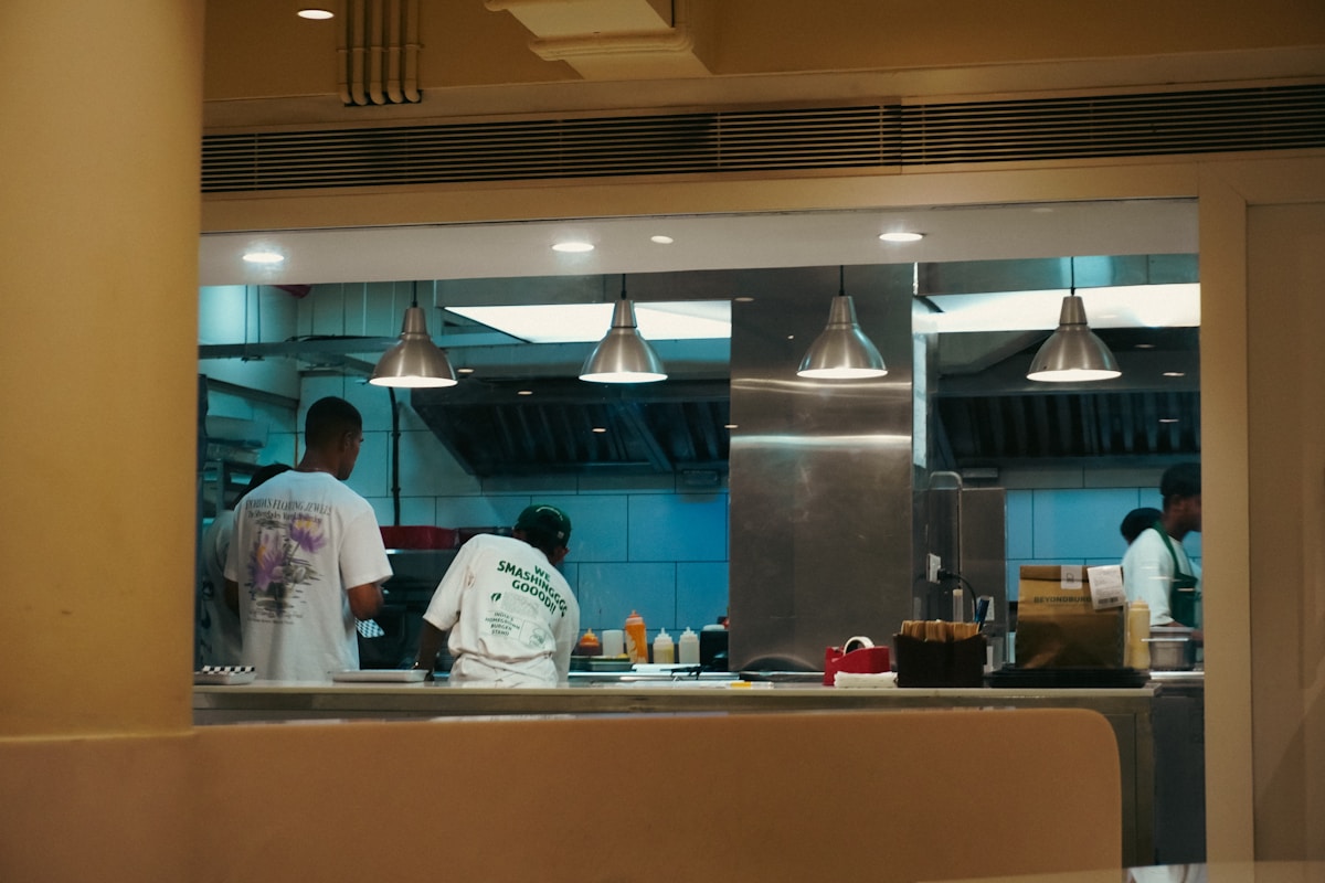 Restaurant kitchen employees preparing food during a shift.