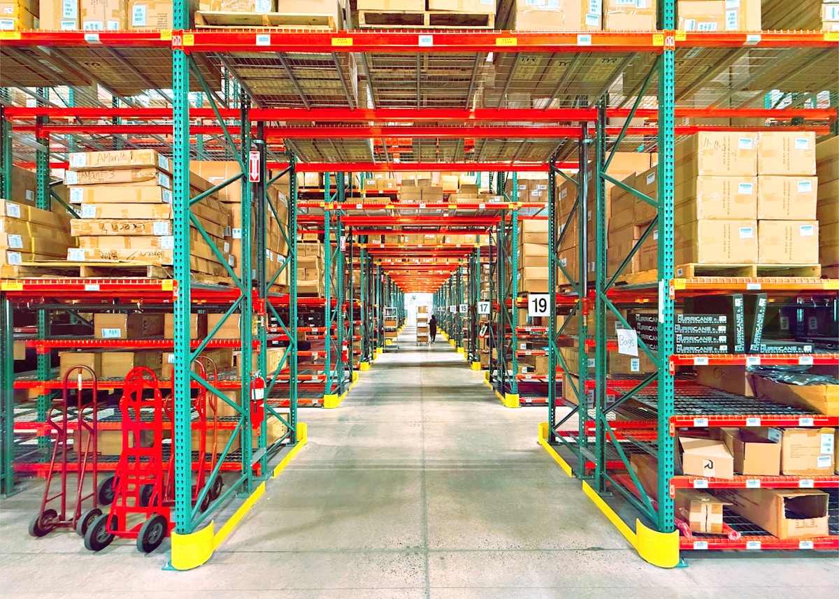 Warehouse aisle lined with stocked inventory racks.